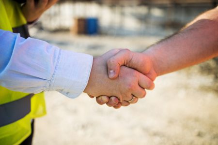 Construction workers hawe work meeting and shake hands